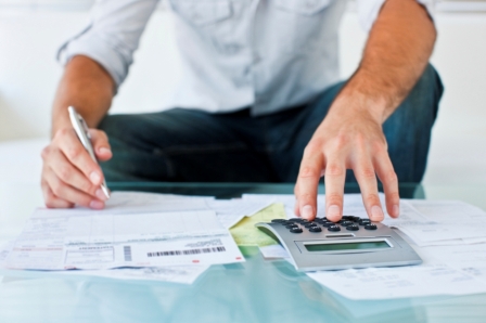 Cropped image of a man calculating his bills